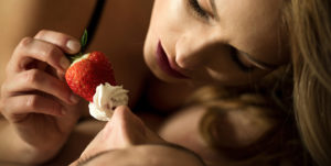 Foreplay with the use of strawberry and whipped cream as an aphrodisiac